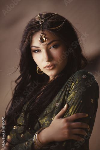 beautiful woman with fashion make up and hairstyle like egyptian princess cleopatra outdoors