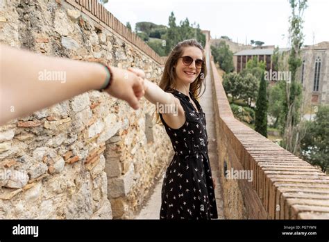 Spain Girona Smiling Woman Holding Mans Hand Walking Along Stone