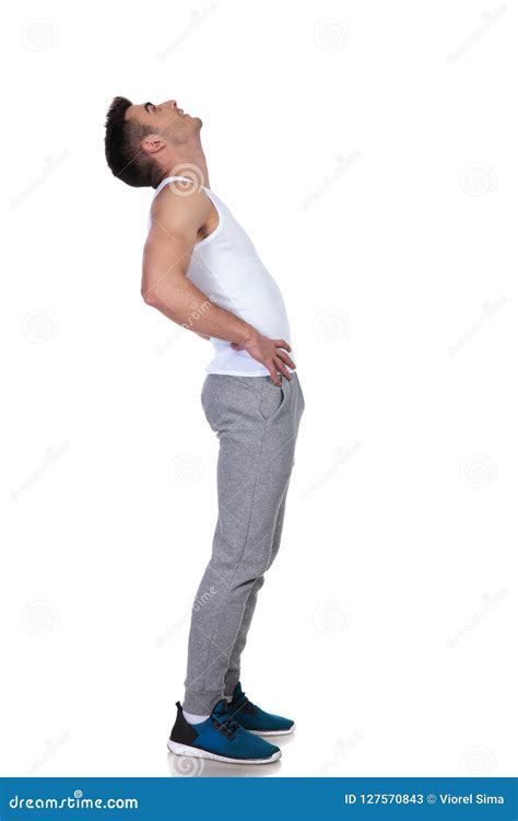 Side View Of Curious Young Man Standing And Looking Up Stock Image