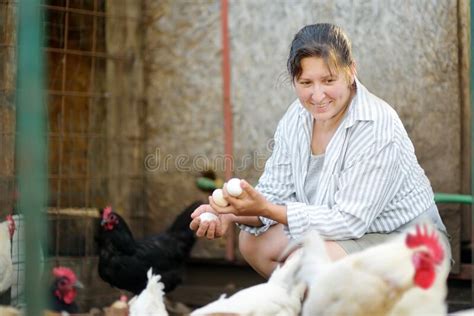 Woman Farmer Collecting Fresh Organic Eggs On Chicken Farm Floor Cage
