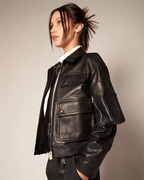 A Woman Wearing A Black Leather Jacket And Pants With A Ponytail In Her