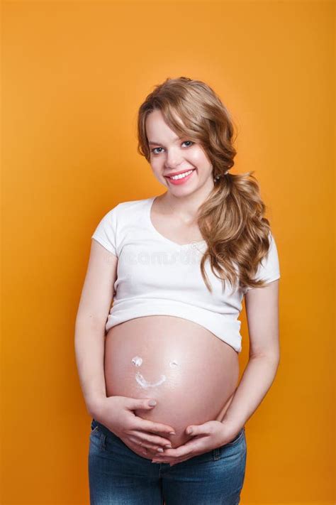 Pregnant Woman With Smile From Moisturizing Cream For Stretch Marks