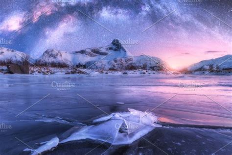Milky Way Above Frozen Sea Coast And Snow Covered Mountains High