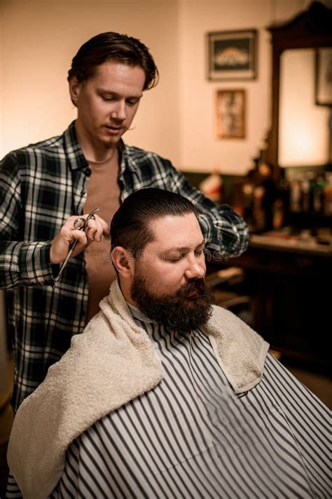 great view on bearded man at barbershop and barber cuts and styles his hair stock image image