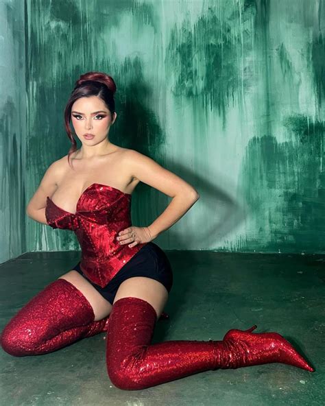 Demi Rose In A Tiny Red Corset Grabs Her Large Chest With Both Hands