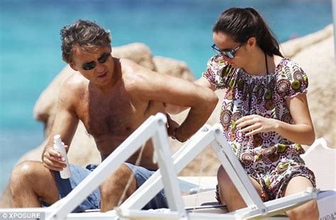 Roberto mancini, the artisan of italy's renaissance. Roberto Mancini shows off his toned body as he protects his skin with sunblock | Daily Mail Online