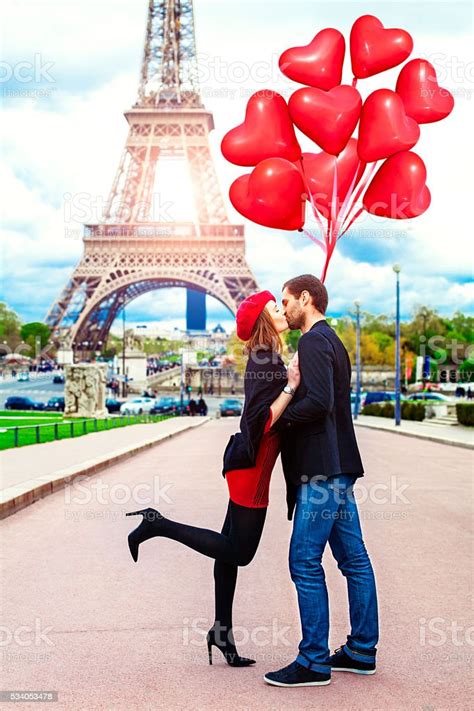 Young Romantic Couple Kissing Near The Eiffel Tower In Paris Stock