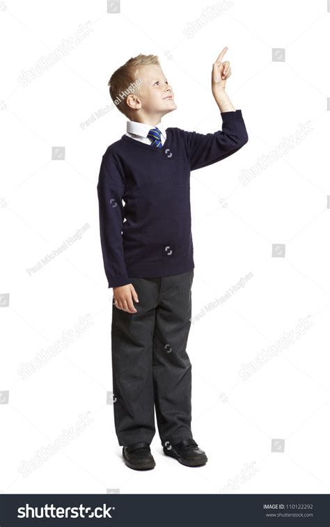 8 Year Old School Boy Pointing Up On White Background