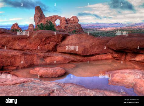 Arches National Park Turret Arch Sunrise With Rocks And Water In