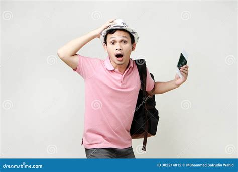 Asian Man Backpacker Holding Passport And Airline Ticket With Shocked