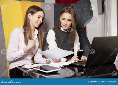 Two Businesswomen At Office Working With Laptop Stock Photo Image Of