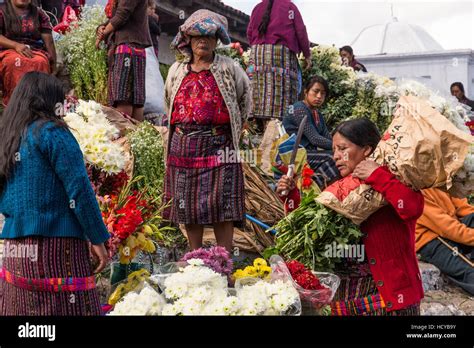 Quiche Mayan Woman In Traditional Dress Selling Flowers On The Steps Of