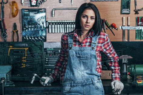 Portrait of female mechanic standing at workshop - Stock Photo - Dissolve