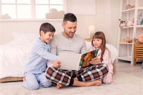 Premium Photo Father And His Little Children Reading Bedtime Story At