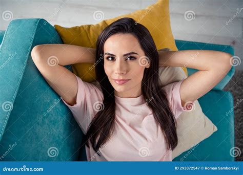top high angle photo of calm lady lying on sofa enjoy rest relax at new living room furniture