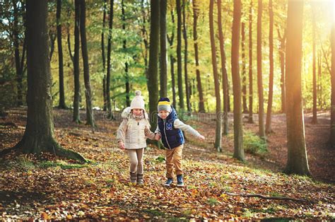 Two Kids Walking Through The Green Forest Stock Image Image Of