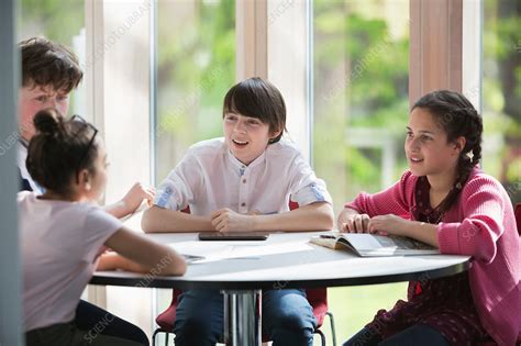 Students Talking At Table Stock Image F0201734 Science Photo Library