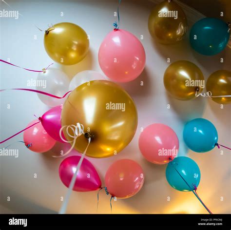 A Bunch Of Balloons From A Celebration Are Filled With Helium And Float