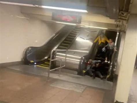 Shocking Moment Two Brawling Men Plummet Down Escalator In Grand