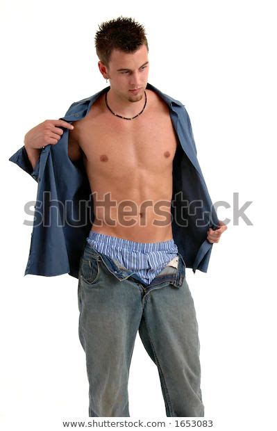 Young Man Taking Off His Shirt Stock Photo 1653083 Shutterstock