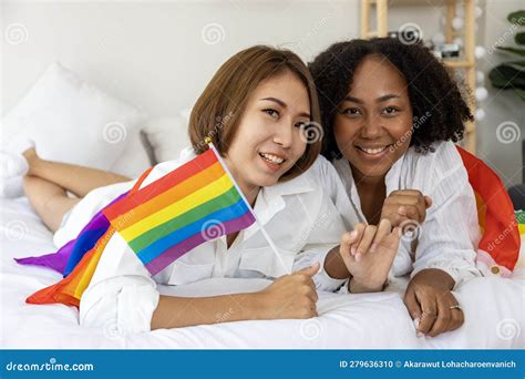 Couple Of Same Sex Marriage From Difference Races With Lgbtq Rainbow Flag For Pride Month While