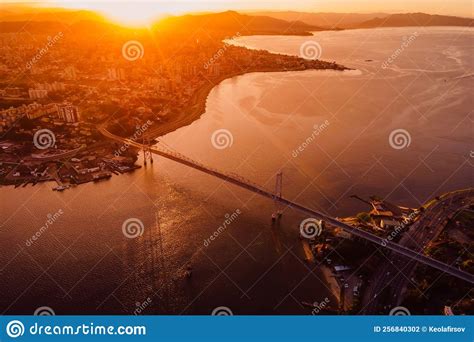 Aerial View Of City And Hercilio Luz Bridge With Bright Sunset In