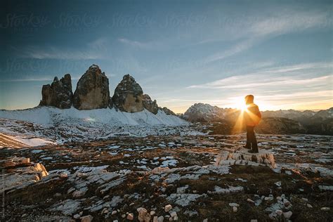 Hiker In Red Jacket In Front Of The Famous Three Peaks At Sunset By