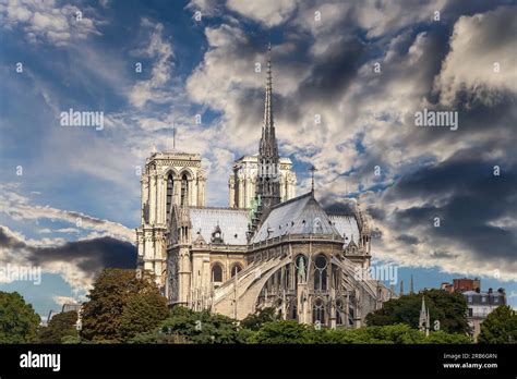 Notre Dame De Paris Against The Background Of Sky With Clouds Also