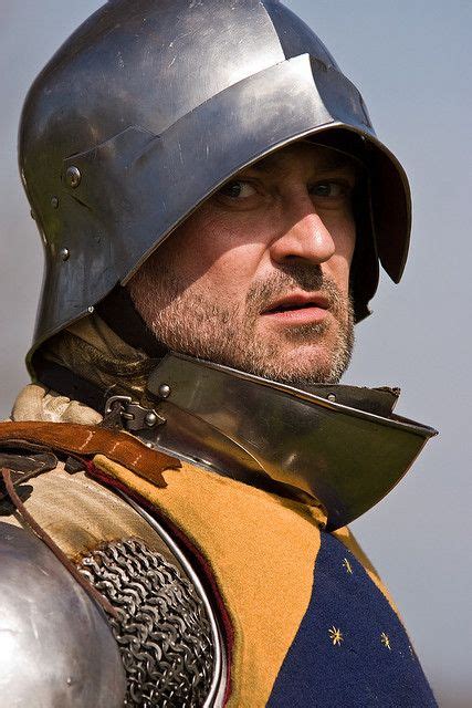 A Close Up Of A Person Wearing A Helmet And Armor