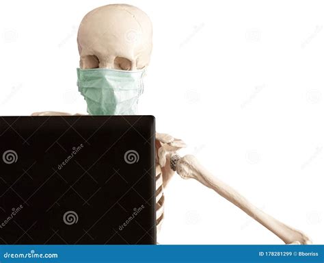 Skeleton In Protective Medical Mask Works With The Laptop Stock Image