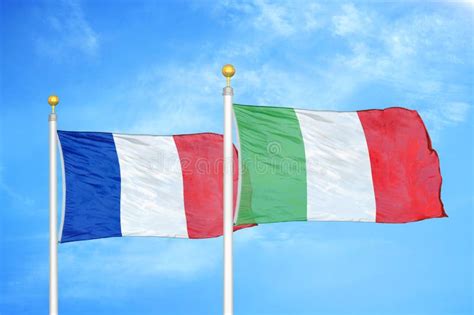 France And Italy Two Flags On Flagpoles And Blue Cloudy Sky Stock Image