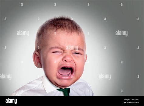 Close Up Of Baby Boy Crying Against White Background Stock Photo Alamy