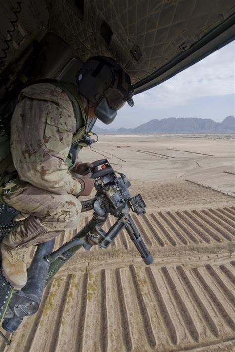 A Door Gunner Provides Security From A Griffon Helicopter During An