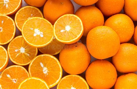 Pile Of Oranges Sliced And Whole Stock Photo Image Of Yellow Closeup
