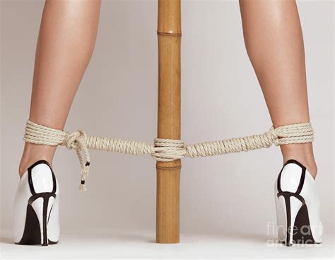 Woman Legs Tied With Ropes To Bamboo Photograph By Oleksiy Maksymenko