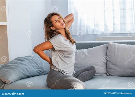 Woman Suffering From Backache At Home Lower Back Pain Stock Image