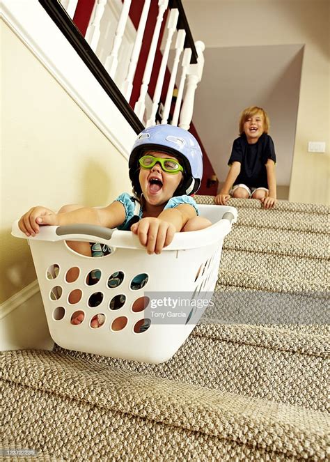 Girl Going Downstairs In A Laundry Basket Bildbanksbilder Getty Images