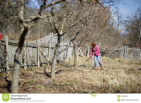 Farmer Woman Spring Cleaning With A Rake Stock Photo Image Of Redhead