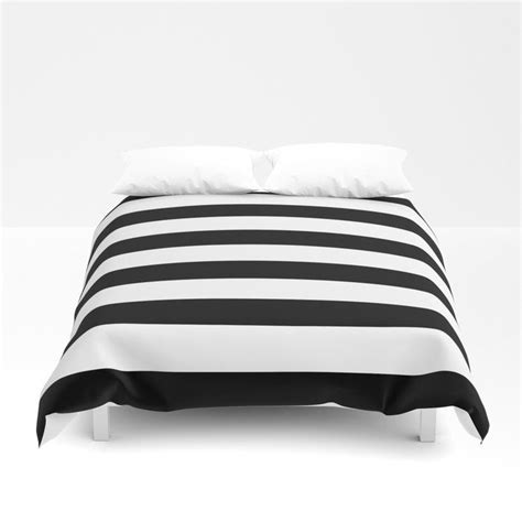 A Black And White Striped Comforter On A Bed
