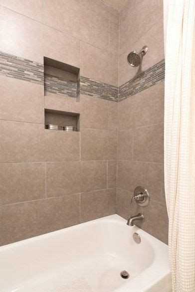 Dark colored bathroom tiles are not good for small bathroom tile designs because they make the space appear smaller. 12 x 24 tile on bathtub shower surround | Bathtub tile ...