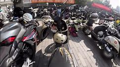 Motorcycles fall like dominoes when well-meaning motorist tries to fix scooter's position