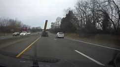 Wooden Board Hits Car's Windshield After Flying Off of Truck