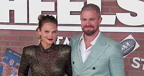 Stephen Amell and Cassandra Jean pose on the Heels red carpet