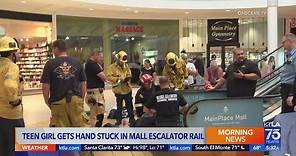 Teen girl gets hand stuck in mall escalator rail