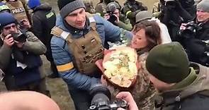 Vitali Klitschko kisses bride as he attends military field wedding