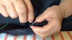 Sewing a button back on a suit jacket