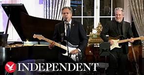 Secretary Antony Blinken plays guitar serenading State Department crowd