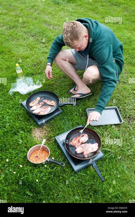 Image of man cooking bacon in pan