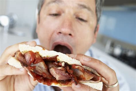 Image of man eating bacon