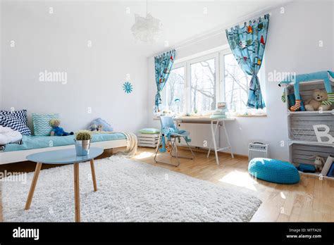 Spacious Light Blue Bedroom with a Large Window